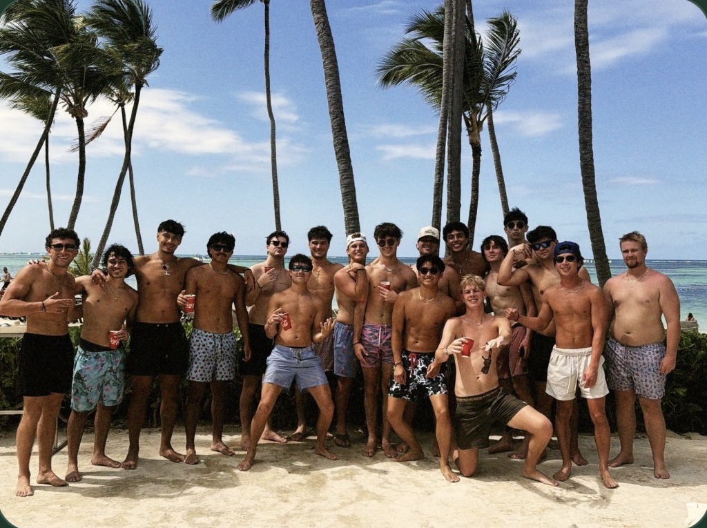 A fraternity chapter gathered on a Punta Cana beach at sunset