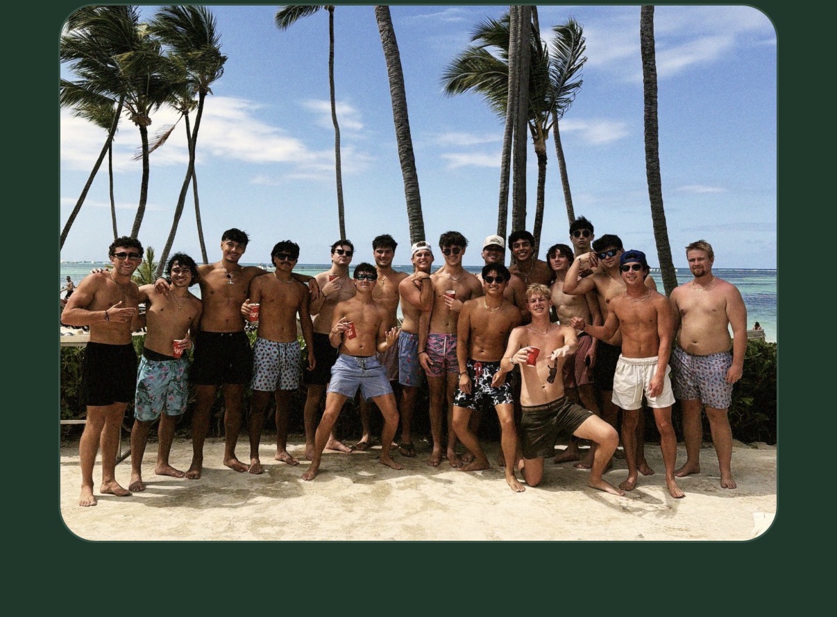 A fraternity chapter gathered on a Punta Cana beach at sunset